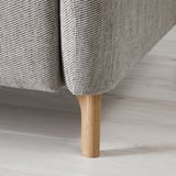 Modern sofa with sleek lines and wooden legs, upholstered in textured gray fabric, emphasizing comfort and style.