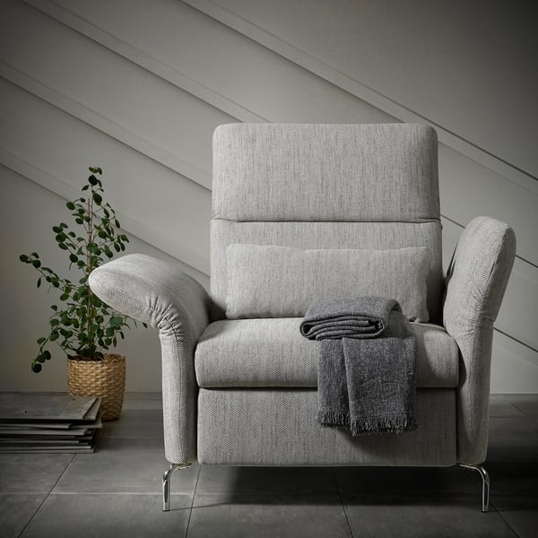 Modern gray tweed FAMMARP recliner with footstool, sleek metal legs, comfy blanket, cozy setup.