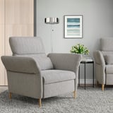 Modern gray FAMMARP fabric armchair, large, between another chair and side table. Art print on wall.