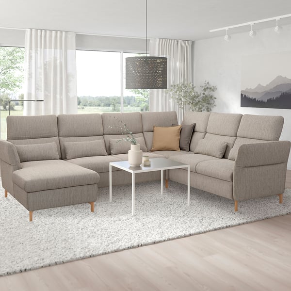 Modern living room with large grey FAMMARP l-shaped sofa, white coffee table, and large window.