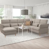 Modern living room with large grey FAMMARP l-shaped sofa, white coffee table, and large window.