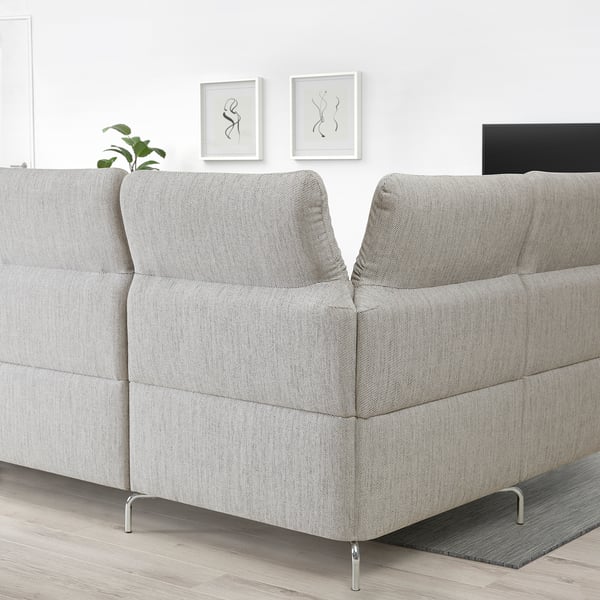 Grey FAMMARP sectional sofa with adjustable headrests and metallic legs in minimalist space.