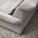 Close-up of a modern, comfortable sofa with adjustable cushions, showcasing high-quality materials and design.