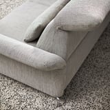 Modern sofa with adjustable headrests, plush cushions and high legs. Upholstered in durable, textured fabric.