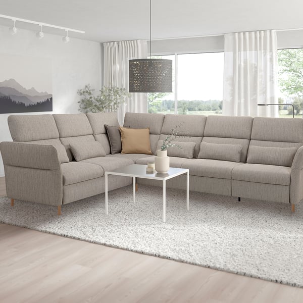U-shaped gray sectional sofa with adjustable parts in bright living room, white coffee table, pendant lamp, large window.