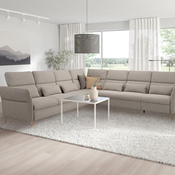 Modern living room with grey FAMMARP sectional sofa, white coffee table, and lamp.