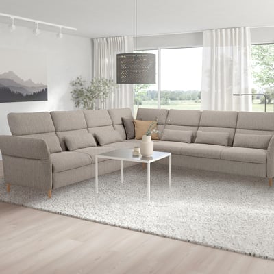 Modern living room: large grey FAMMARP l-shaped sofa, white coffee table, large windows, natural light.