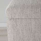 Close-up of a neutral-toned, textured fabric cushion, showcasing high-quality, woven material with a subtle pattern.