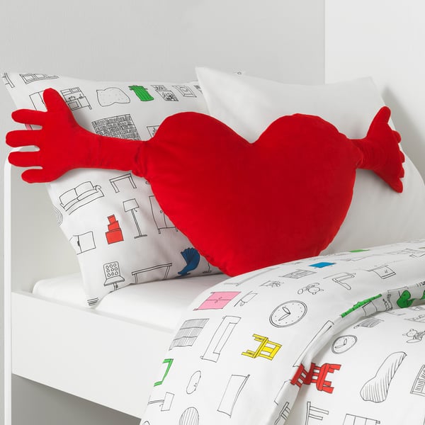 Red heart pillow, white blanket arm pattern.