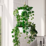 FEJKA artificial plants in white pots near window.