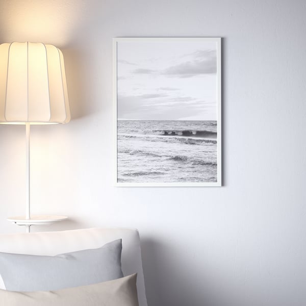 FISKBO frame with ocean photo above bed