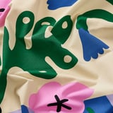 Pre-cut cotton fabric showcasing vibrant, abstract floral patterns. High-quality, vivid colors and smooth texture evident. Ideal for sewing projects.