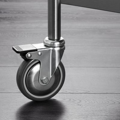 Wheel close-up. Stainless steel castor. Lockable, sturdy design. Ideal for kitchen furniture.