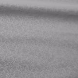 Gray roller blind with subtle white circular pattern, laid out neatly, showcasing smooth and even texture.