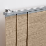 Panel curtains with light filtering, attached to a wall rail. Simple and efficient for privacy and light control.