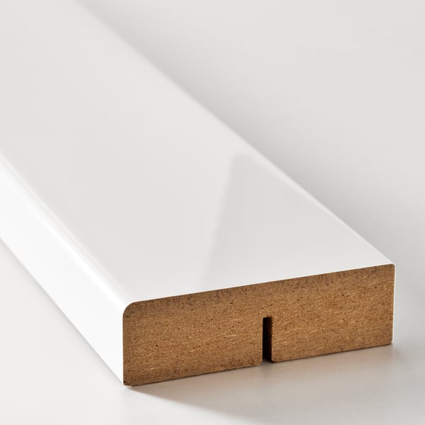 Modern white glossy shelf, supported by sturdy wooden bracket.