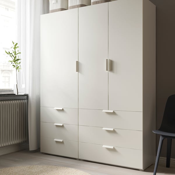 White wardrobe unit with drawers, clean design, handles on doors and drawers.