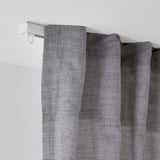 White ceiling-mounted curtain rail with gray textured curtains, showcasing FRAMFUSIGs adjustable rail system.