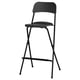 Black FRANKLIN bar stool with oak veneer seat and metal legs, designed for easy folding and storage.