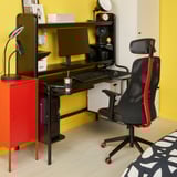 Yellow home office with FREDDE gaming desk & chair, monitor, lamp, cabinets.