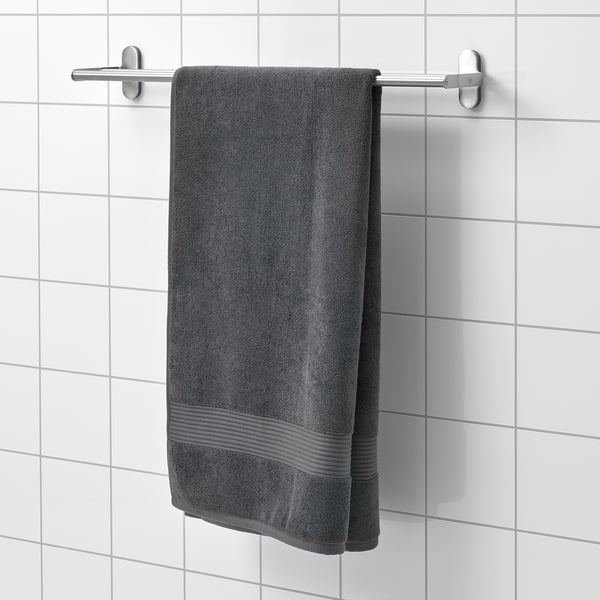Gray FREDRIKSJÖN towel hangs on wall rack, soft cotton, rectangular.