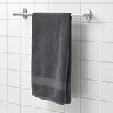 Gray FREDRIKSJÖN towel hangs on wall rack, soft cotton, rectangular.
