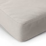 Close-up of soft, textured cushion, showcasing quality recycled fabric and meticulous stitching.