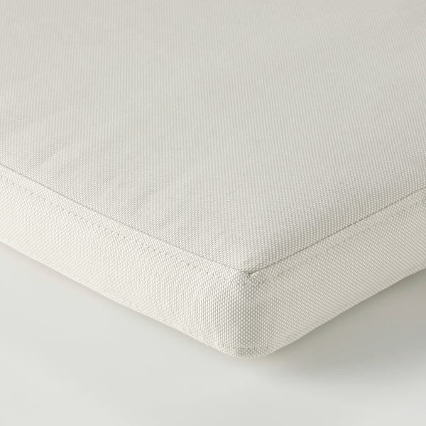Close-up of smooth, beige cushion cover with clean stitching and even texture, showcasing quality material.