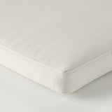Close-up of smooth, beige cushion cover with clean stitching and even texture, showcasing quality material.