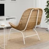 White wicker chair with cushion in modern living room.
