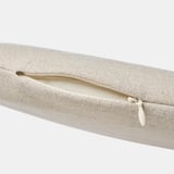 Close-up of well-crafted, beige woven rattan pouch with zipper detail; highlights quality texture.