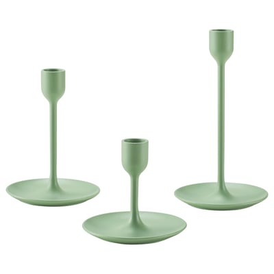 Three modern green candlesticks, varying in height, with sleek design and felt bases for stability.
