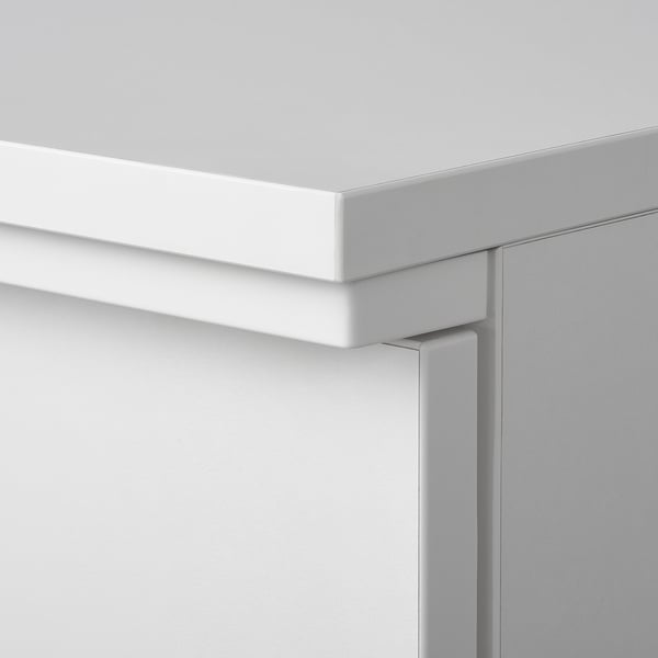 Close-up of durable white cabinet edge showing quality finish and precise craftsmanship.