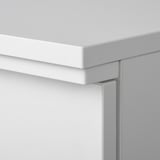Close-up of durable white cabinet edge showing quality finish and precise craftsmanship.