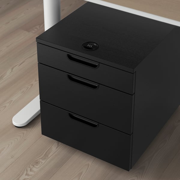 Black mobile filing cabinet with combination lock, three drawers, on wooden floor.