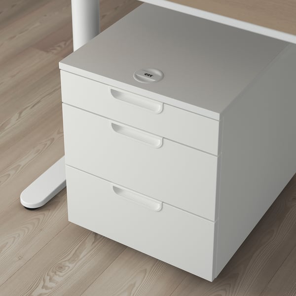 White GALANT filing cabinet with 3 drawers, lock, on castors, under desk.
