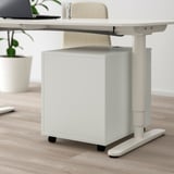 Under-table storage with lock; wheels; silent-close drawer.