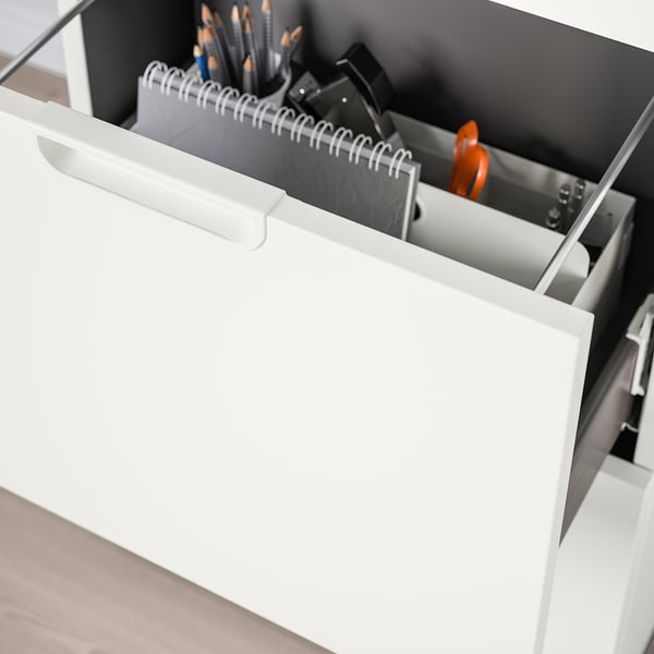 Open office drawer with pens, notebooks, and small tools neatly organized. Part of GALANT storage system.