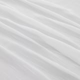 Elegant sheer curtains with delicate patterns, offering privacy and allowing soft daylight through.