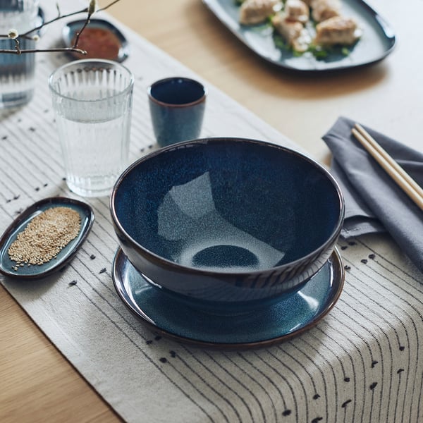GLADELIG blue bowl, stoneware, deep, round, textured glaze, chopsticks, napkin, sesame seeds, water glass.