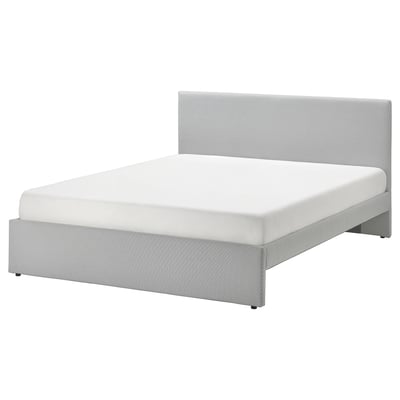 Modern gray upholstered bed with padded headboard, clean lines, and under-bed storage.