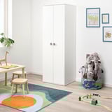 White GODISHUS wardrobe in kids room, large, round knobs, with colorful toys.