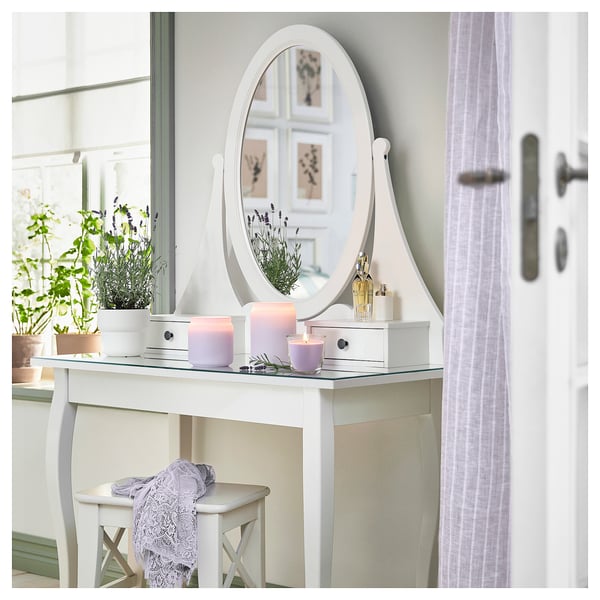 Vanity with mirror, candles, lavender, stool.