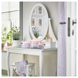 Vanity with mirror, candles, lavender, stool.