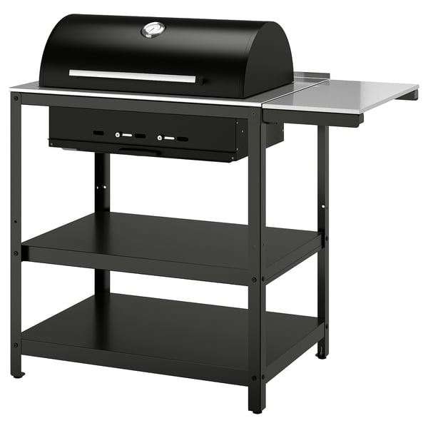 Black GRILLSKÄR grill on stand, stainless steel, domed hood, side shelves.