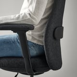 Office chair with adjustable armrests and headrest for comfort and support.