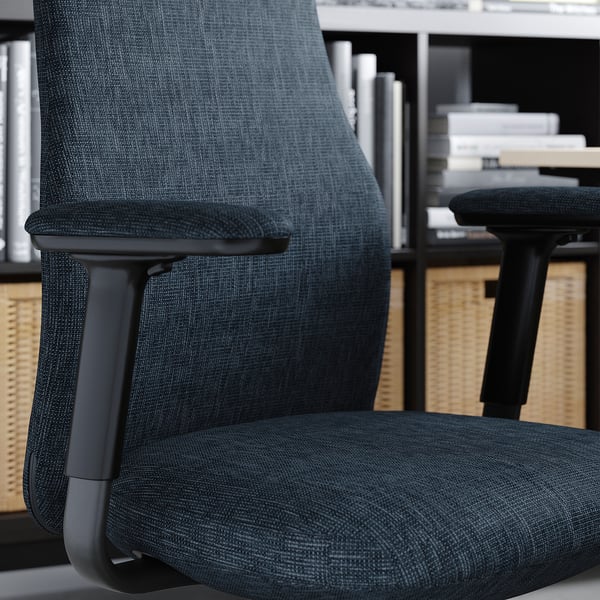 Black GRÖNFJÄLL office chair with armrests, upholstered in dark fabric, set in an office environment.