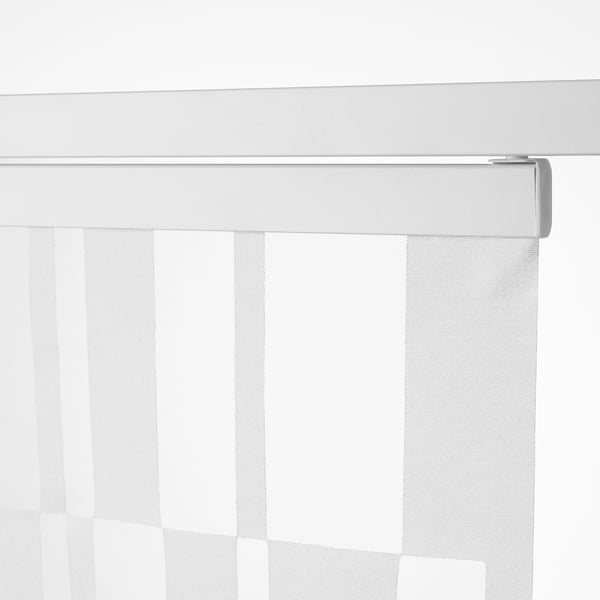 Close-up of a sheer white vertical blind partially drawn, controlled by a metallic wand.