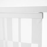 Close-up of a sheer white vertical blind partially drawn, controlled by a metallic wand.