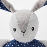 Soft toy with grey ears, blue polka-dot shirt, simple smiling face, safe and baby-friendly.